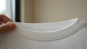 Macro photo of ribbed neckline being stretched for elasticity on a cotton T-shirt