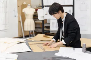 A realistic apparel development workspace showing how pattern pieces are drafted and reviewed before sampling.