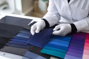 A textile inspection scene showing dyed fabric swatches used to explain how color fastness is evaluated across different materials.