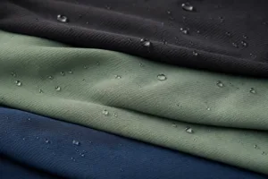 A clean editorial scene showing how moisture-wicking fabrics spread liquid across the surface.